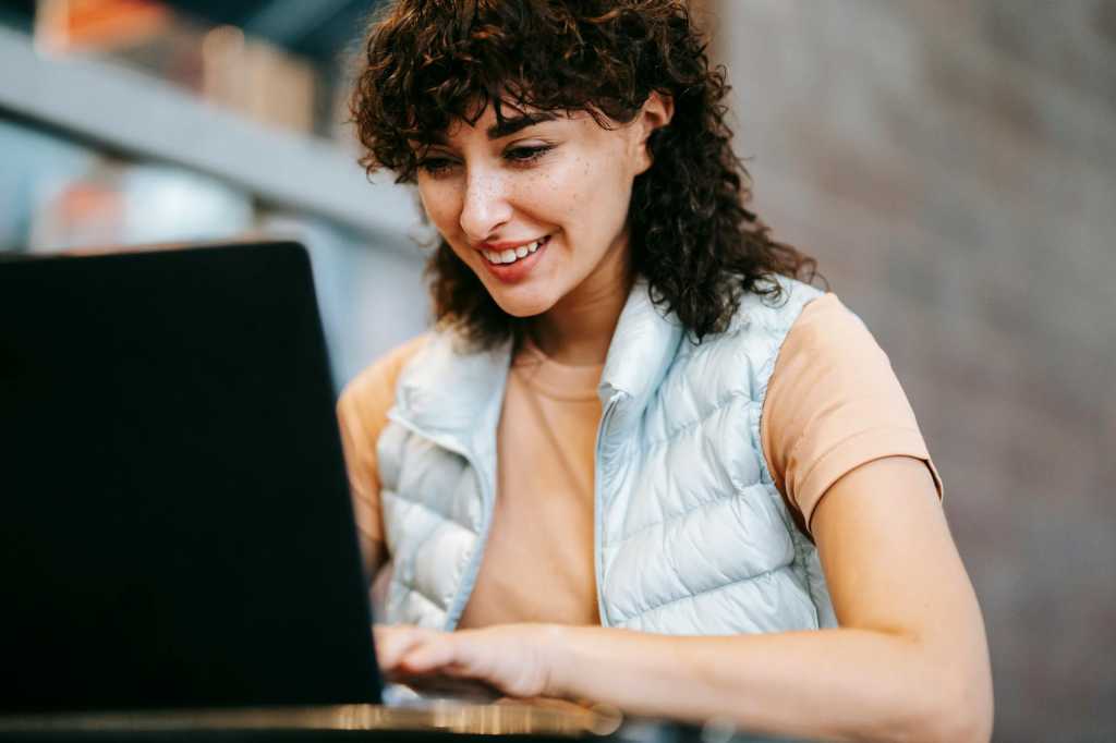 smiling worker at laptop